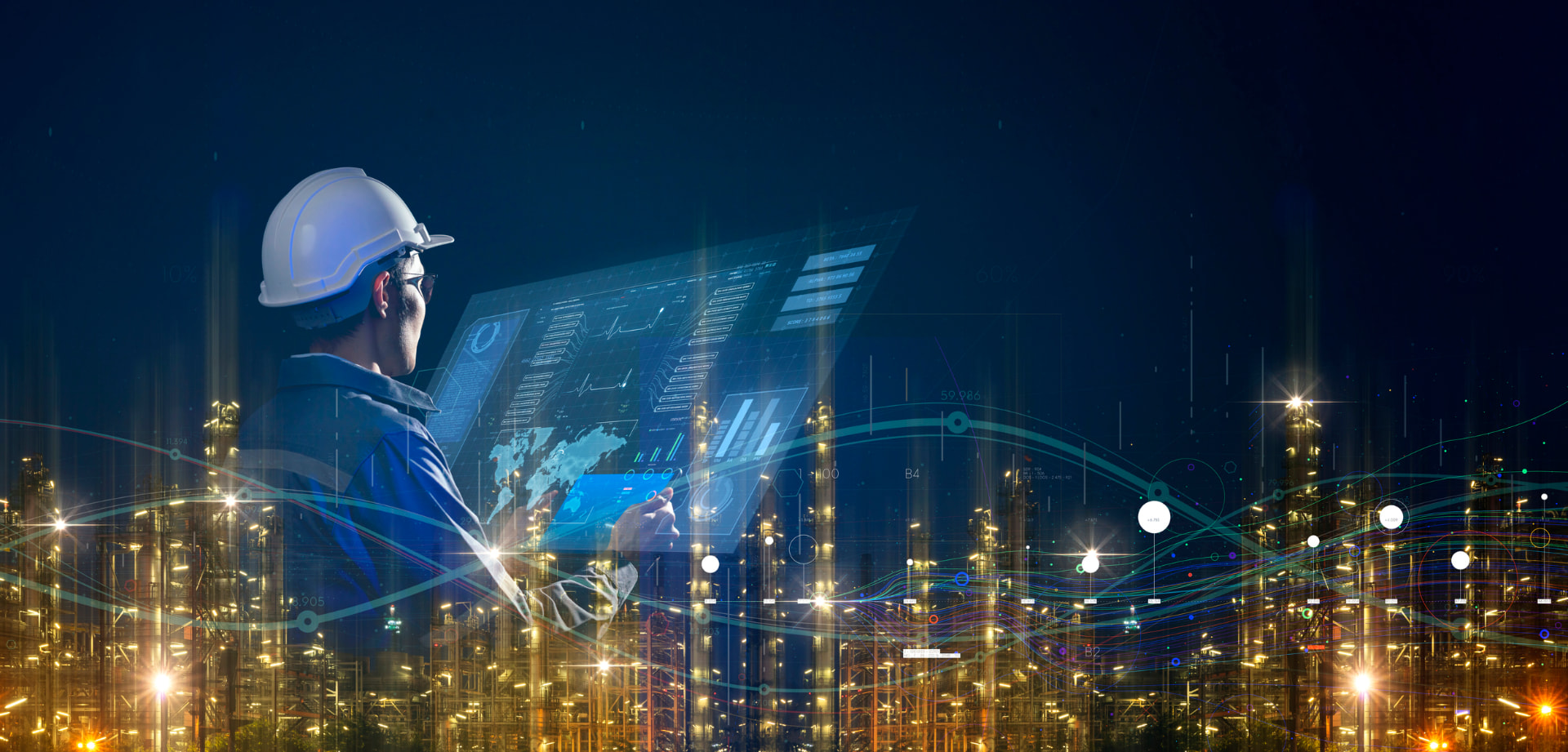 Engineer monitoring a digital power plant dashboard at night