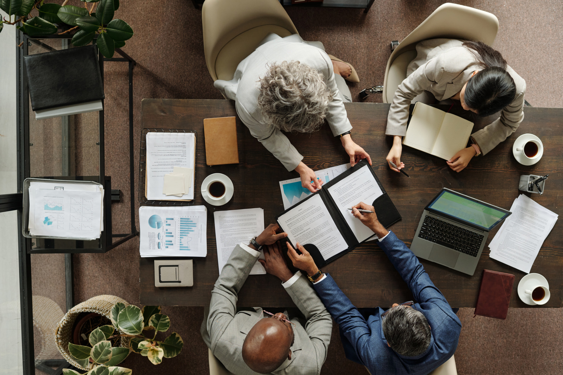 Overhead view of a team reviewing documents in a meeting