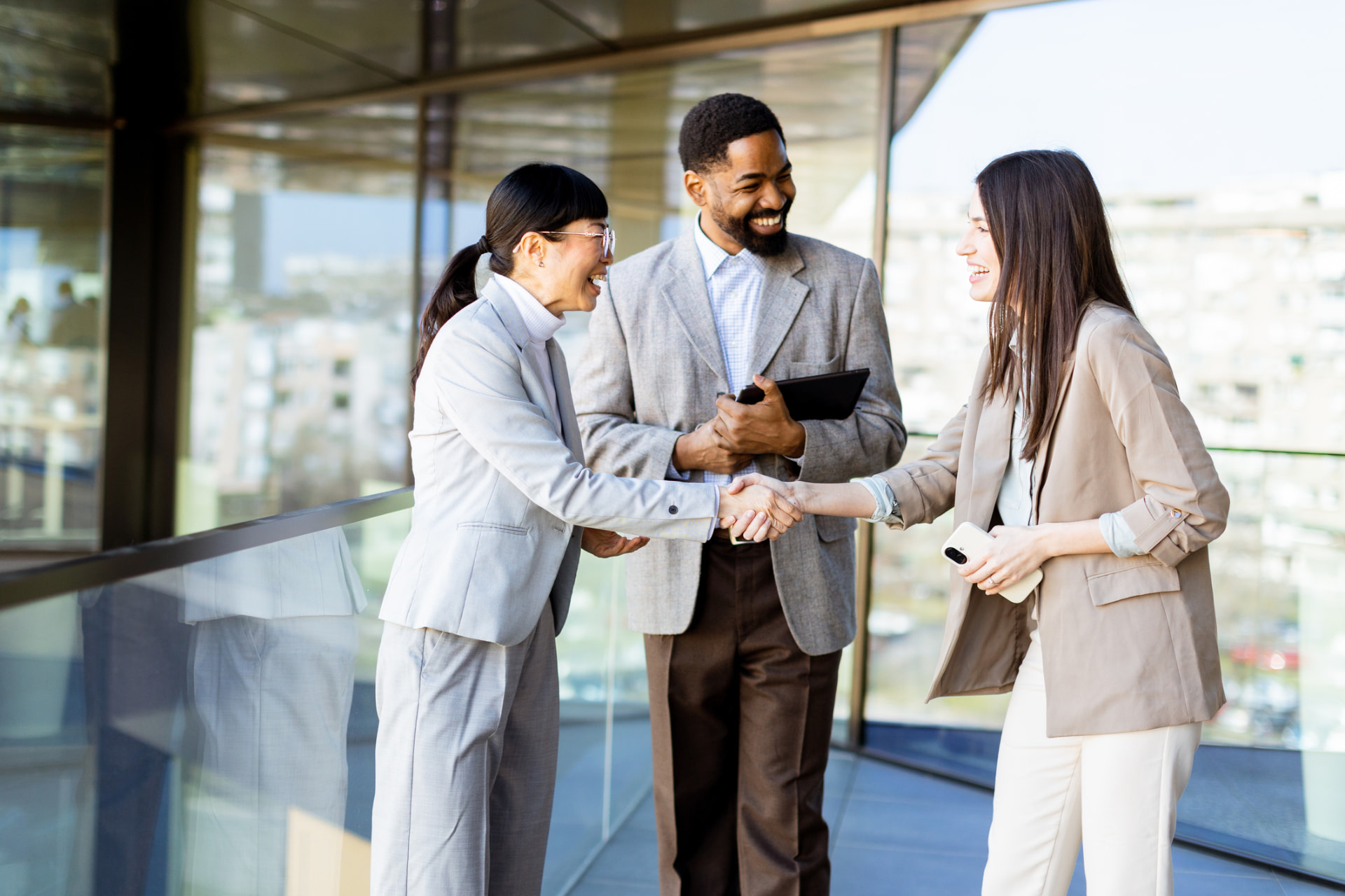 Colleagues shaking hands in a modern office